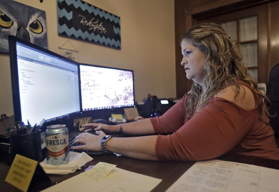 Coral Nichols, vice president and co-founder of Empowered to Change Inc., works in her office Wednesday, Nov. 7, 2018, in Seminole, Fla. Coral is one of around 1.4 million Floridians who stand to get their voting rights back after serving their time for committing a felony. Florida added 1.4 million possible voters to the rolls when it passed Amendment 4, which said most felons will automatically have their voting rights restored when they complete their sentences and probation. (AP Photo/Chris O'Meara)