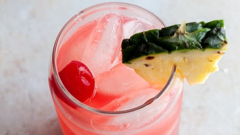 Pineapple and cherry garnishing cocktail