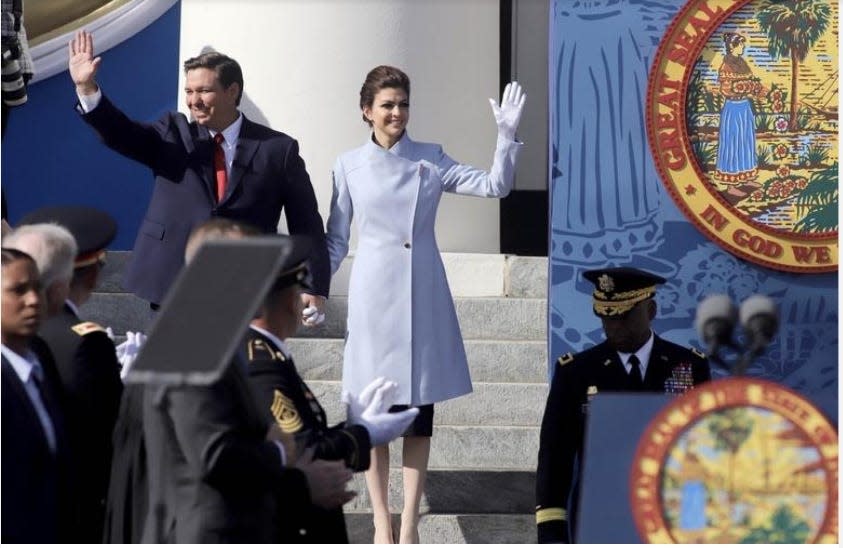 Ron DeSantis and his wife, Casey, wave as they arrive for the inaugural ceremony at Florida's Capitol. [MICHAEL SNYDER/Northwest Florida Daily News]