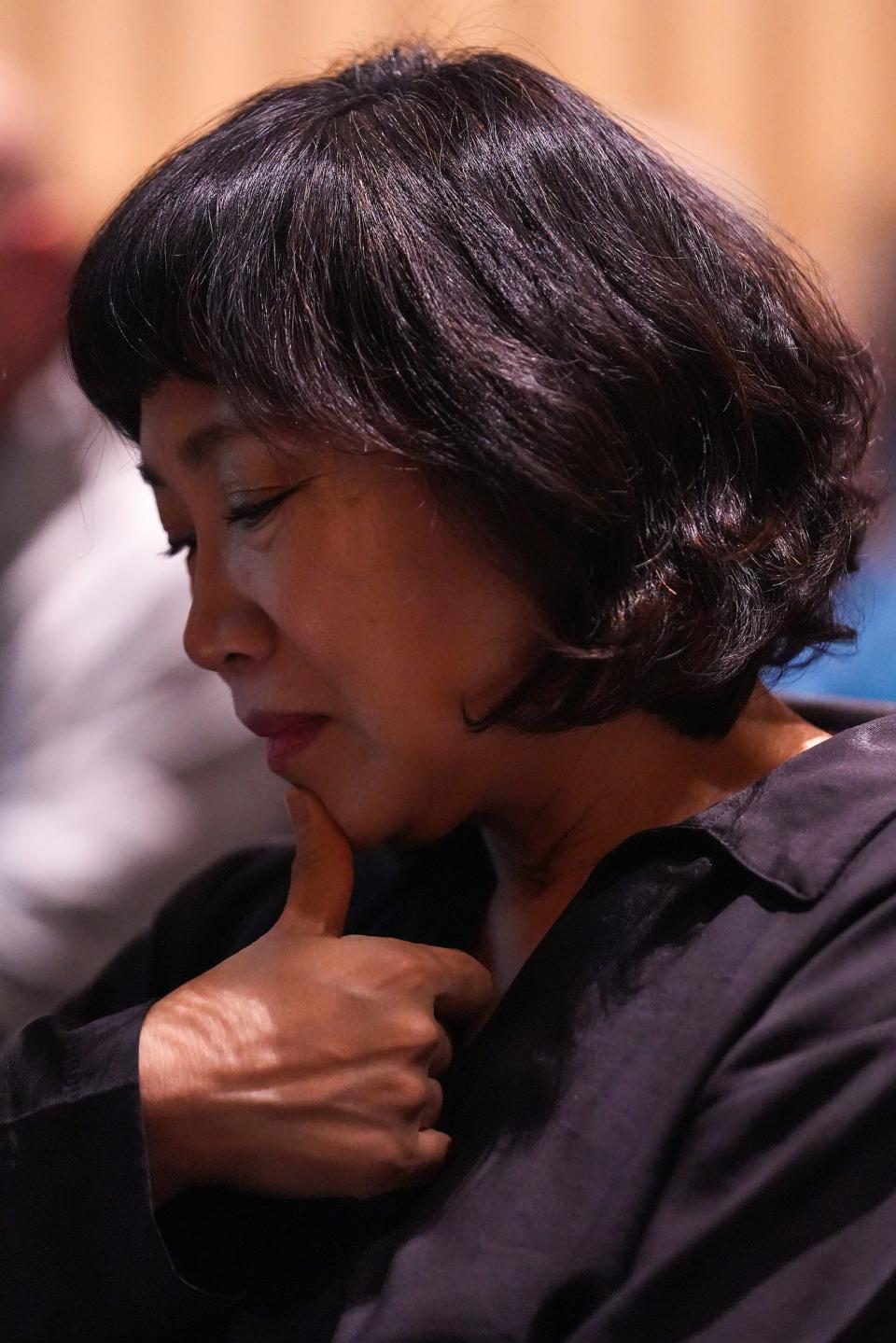 Jiny Kim, sister of Yeon-Su Kim, looks down as she listens to her brother Se Yong Kim speak about their late sister during a memorial service for Yeon-Su Kim and Corey Allen at Cline Library Assembly Hall of NAU on Saturday, Dec. 10, 2022, in Flagstaff. The couple was lost at sea off the coast of Puerto Peñasco, Mexico, while kayaking on Thanksgiving.