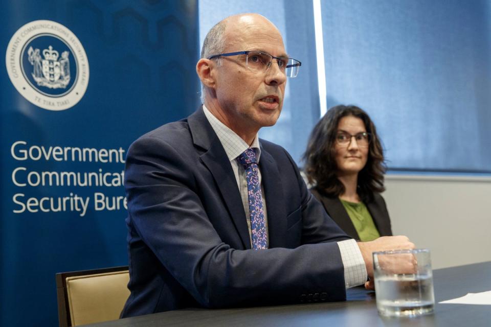 New Zealand's Government Communications Security Bureau Director-General Andrew Clark, left, and the Deputy Director-General Lisa Fong speak at Defence house in Wellington (AP)