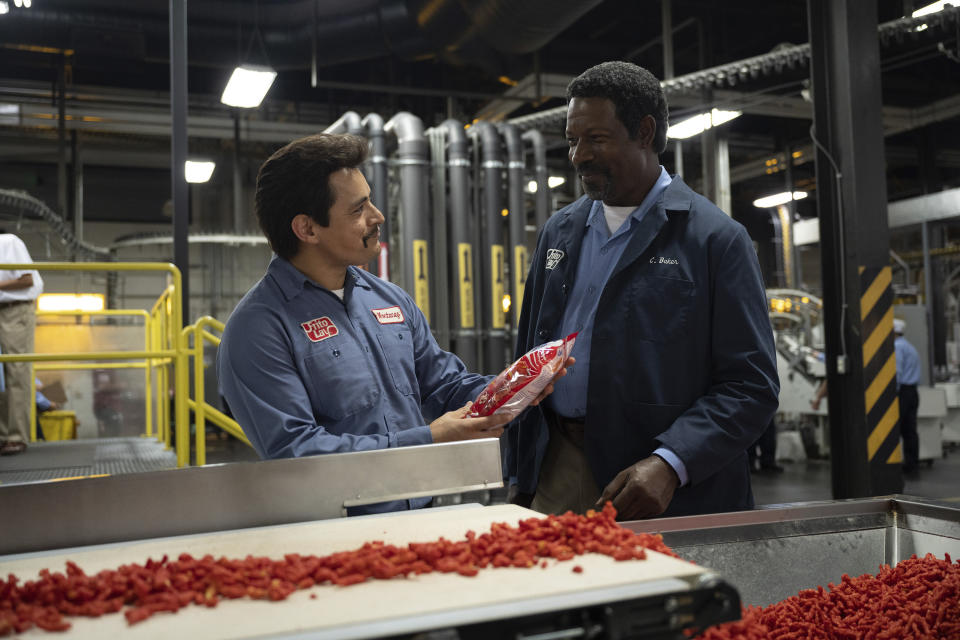 This image released by Searchlight Pictures shows Jesse Garcia, left, and Dennis Haysbert in a scene from "Flamin' Hot," a tale of how a Mexican American janitor came up with the idea for Flamin’ Hot Cheetos. (Anna Kooris/Searchlight Pictures via AP)