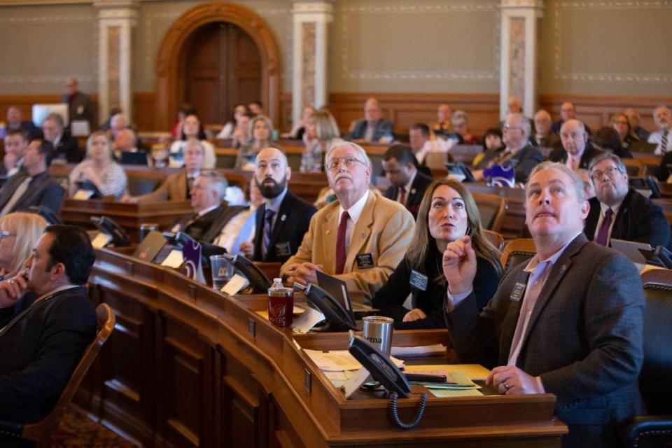 Kansas House Republican members watch the voting boards last month as representatives voted to override a veto on a bill that bans transgender athletes from women’s sports.