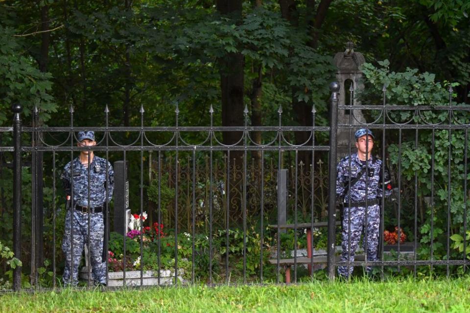 Rosgvardia servicemembers stand guard at the Porokhovskoye cemetery in St. Petersburg, where Wagner boss Yevgeny Prigozhin was buried in August 2023. (Olga Maltseva/AFP via Getty Images)