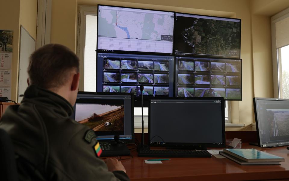 A Lithuanian border guard monitors the video feed from cameras along the border to the Russian semi-exclave of Kaliningrad in Vistytis, Lithuania