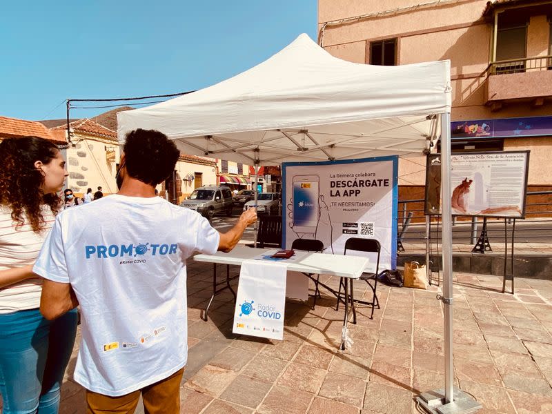 Volunteers show residents how to install an app to trace contacts with people potentially infected with the coronavirus disease (COVID-19) being trialled on the Canary Island of La Gomera