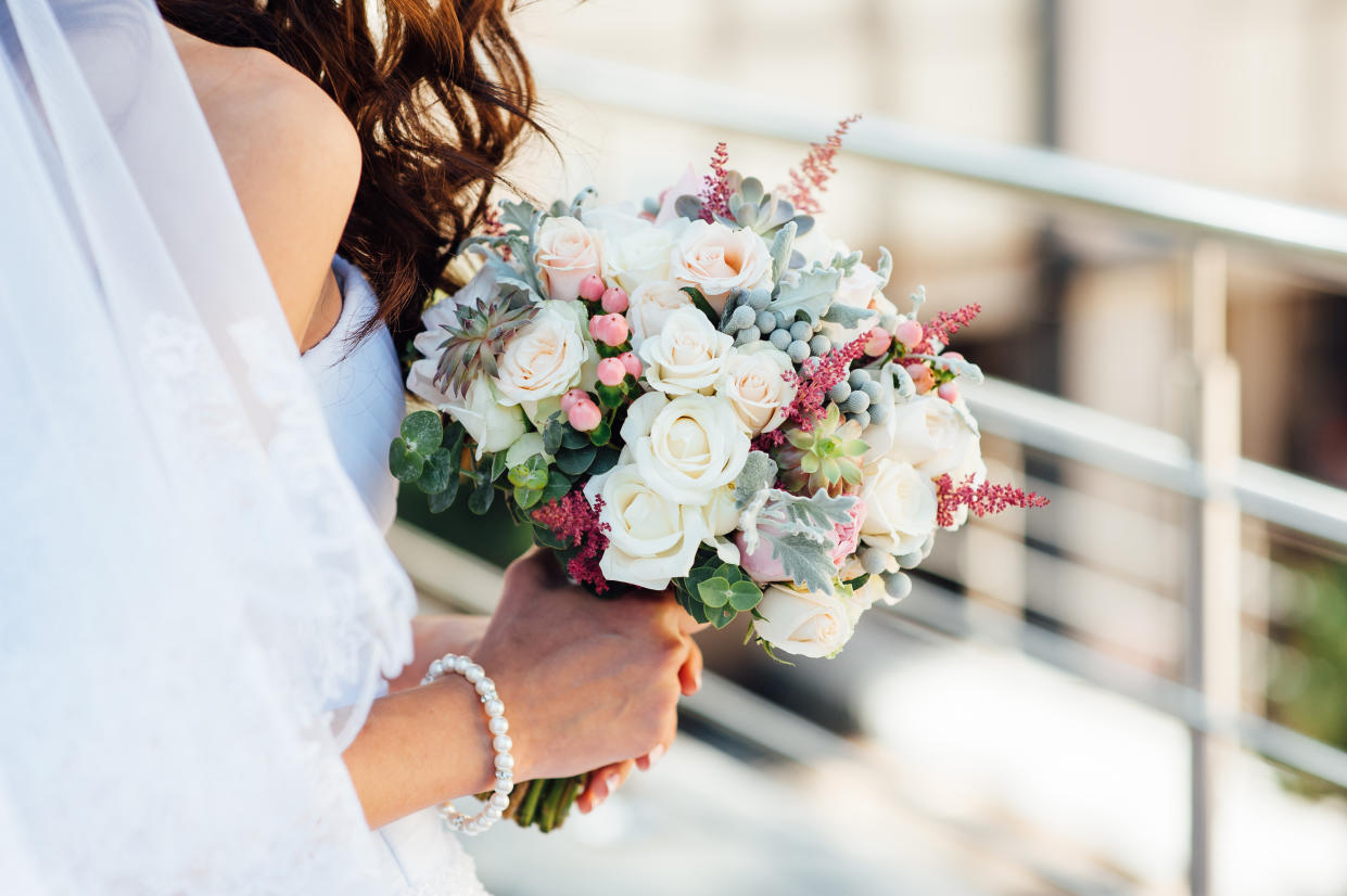 beautiful bouquet in hands of the bride is very stylish with light hair