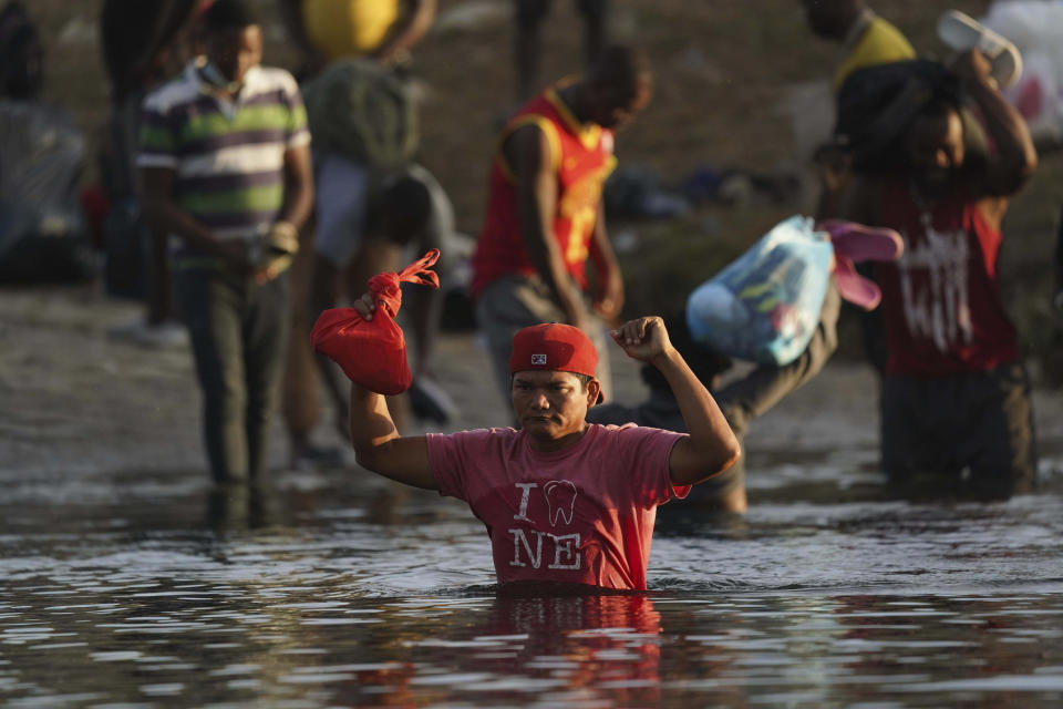 A migrant from Honduras wades across the Rio Grande river to leave Del Rio, Texas and return to Ciudad Acuna, Mexico, early Wednesday, Sept. 22, 2021, to avoid possible deportation from the U.S. (AP Photo/Fernando Llano)