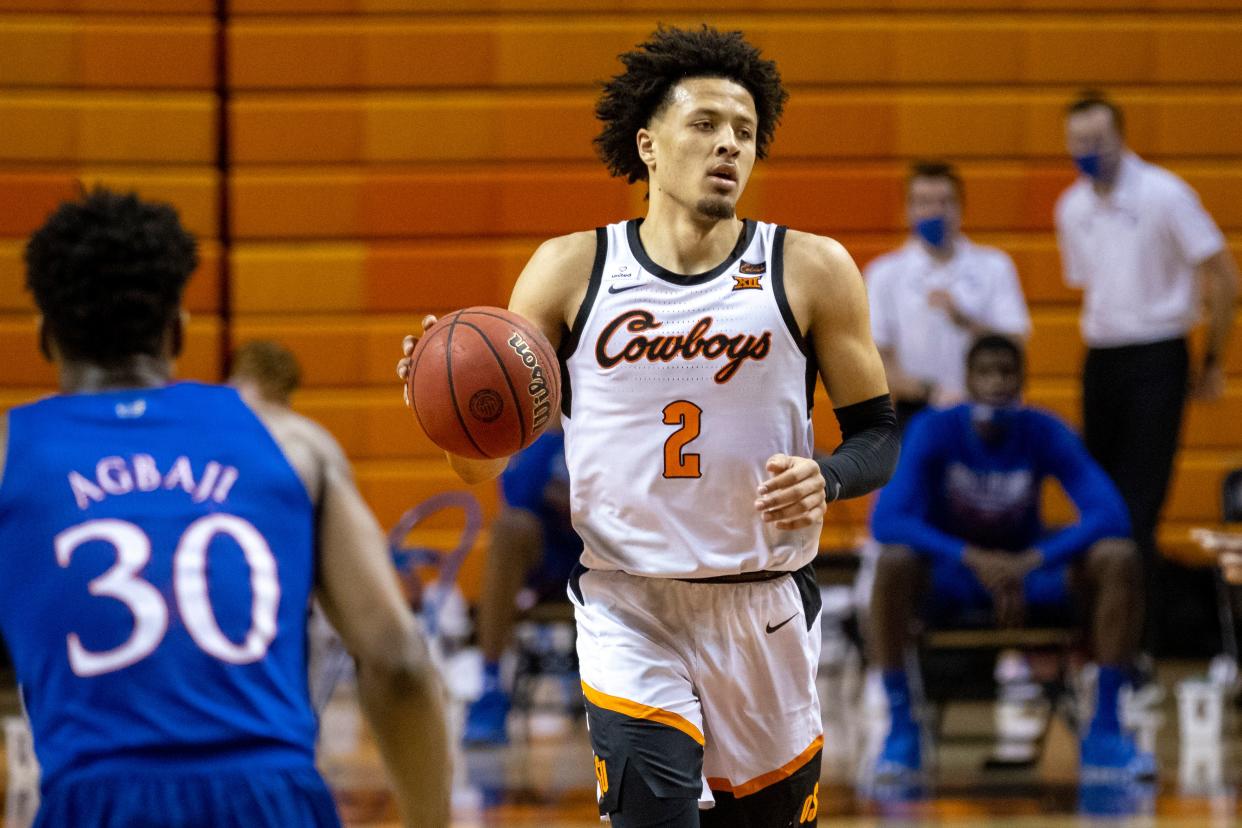 Oklahoma State's Cade Cunningham brings the ball up the court his team's game against Kansas in Stillwater, Okla., Tuesday, Jan. 12, 2021.