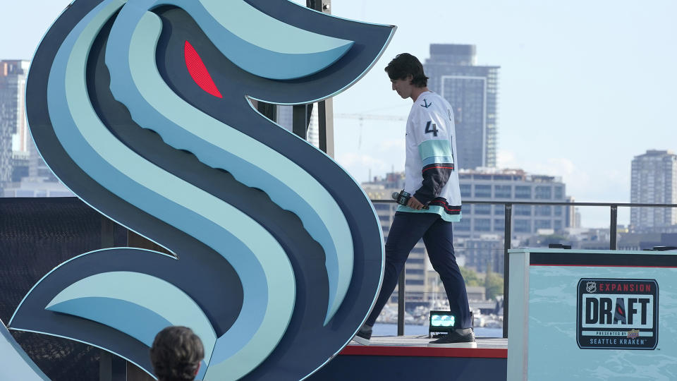 Hadyn Fluery, a defenseman from the Anaheim Ducks, walks off stage after being introduced as a new player with the Seattle Kraken NHL hockey team, Wednesday, July 21, 2021, during the Kraken's expansion draft event in Seattle. (AP Photo/Ted S. Warren)