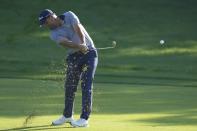 Richard Bland of England plays his second shot on the 9th hole during the completion of his second round on Day Three of the Dubai Desert Classic, in Dubai, United Arab Emirates, Saturday, Jan. 28, 2023. (AP Photo/Kamran Jebreili)