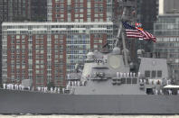 Sailors on the USS Roosevelt stand at attention as they pass the World Trade Center site as seen from Jersey City, N.J., Wednesday, May 23, 2012. Naval vessels ranging from a U.S. amphibious assault ship to a Finnish minelayer are participating in New York City's Fleet Week. (AP Photo/Seth Wenig)
