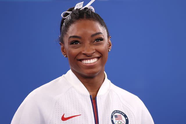 <p>Laurence Griffiths/Getty Images</p> Simone Biles of Team United States smiles during the Women's Team Final on day four of the Tokyo 2020 Olympic Games