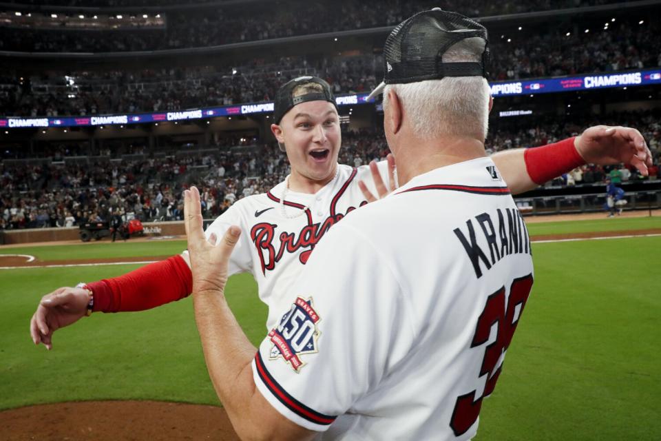 Atlanta Braves' Joc Pederson, left, celebrates with pitching coach Rick Kranitz