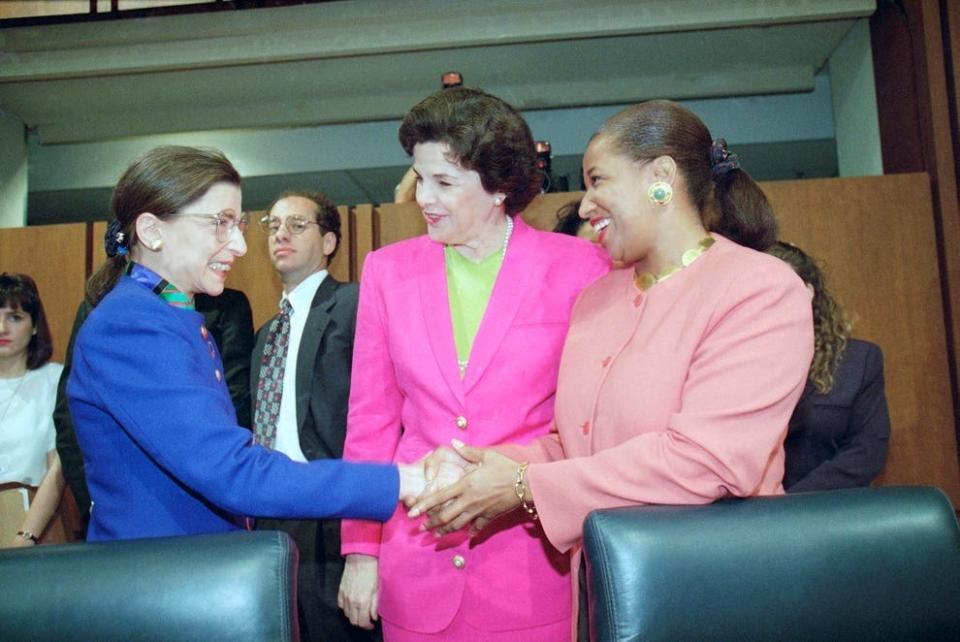 Supreme Court nominee Ruth Bader Ginsburg shakes hands with Sen. Carol Moseley-Braun, D-Ill., as Sen. Dianne Feinstein, D-Calif., looks on prior to Ginsburg's confirmation hearing before the Senate Judiciary Committee on July 20, 1993.