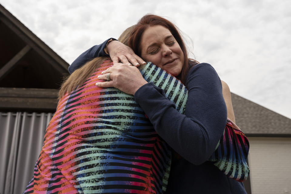 Misti Gossett hugs her sister, Angie Marchese, at her home in Hernando, Miss., on Nov. 1, 2022. (Andrea Morales for NBC News)