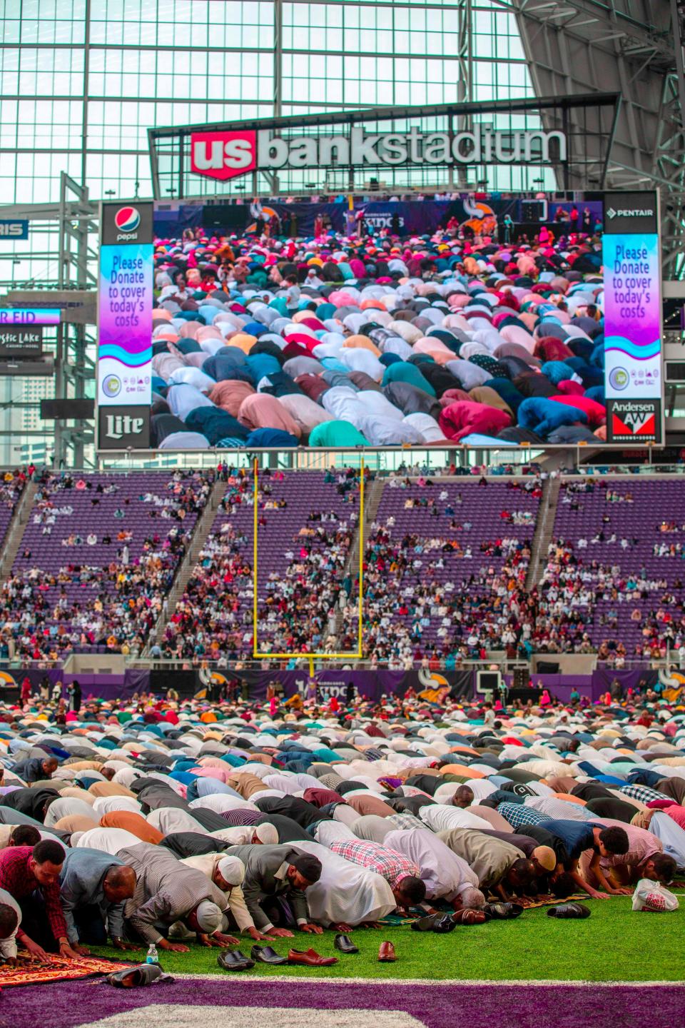 Muslim worshippers kneel in prayer at the US Bank Stadium during celebrations for Eid al-Adha on August 21, 2018 in Minneapolis, Minnesota. - The US Bank Stadium, home of the National Football League's Minnesota Vikings, is hosting thousands for the event that organizers are calling Super Eid.  The holiday, one of the holiest of the year for Muslims, honors the Prophet Ibrahim, also known as Abraham in Judaism and Christianity, and comes at the end of annual hajj pilgrimage. (Photo by Kerem Yucel / AFP)