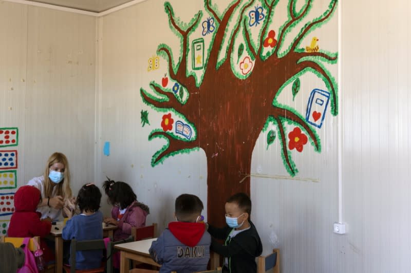 Children attend a class at a school in the Ritsona camp for refugees and migrants