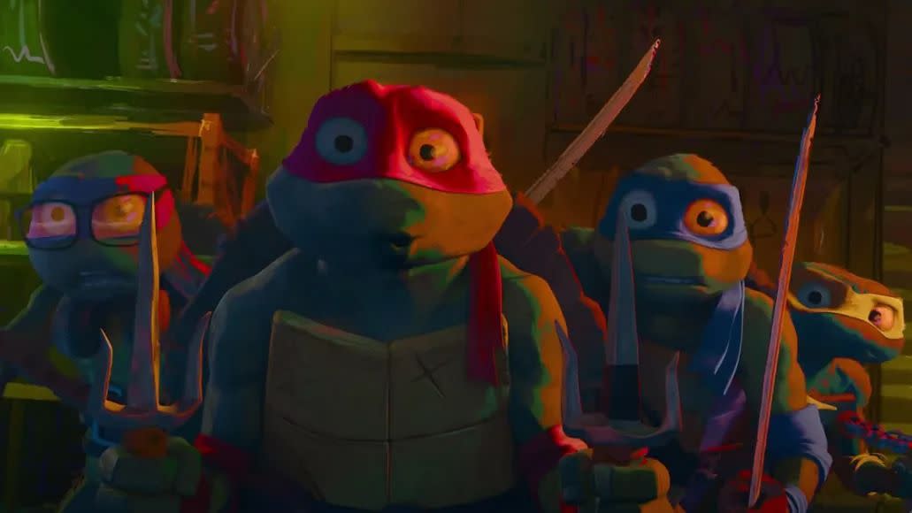 the ninja turtles look frightened in a scene from teenage mutant ninja turtles mutant mayhem, a good housekeeping pick for best kids' movies 2023