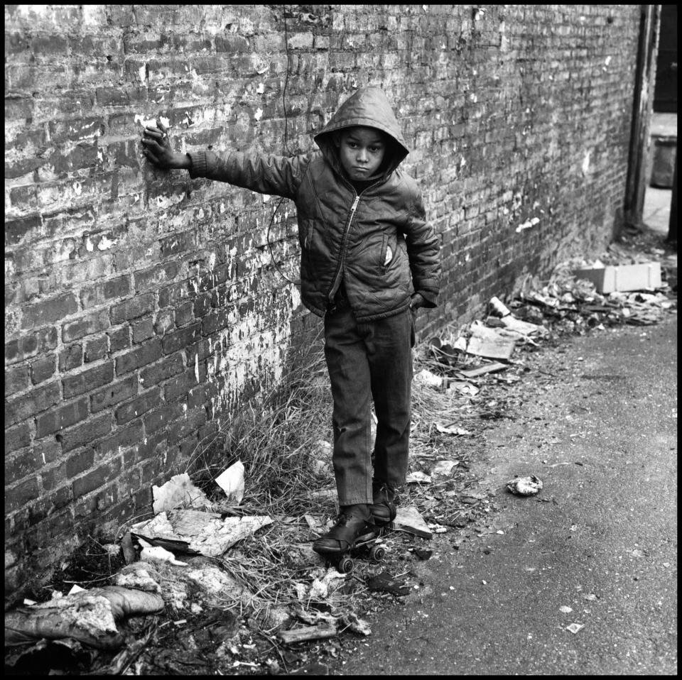 “This is a photograph from my project East 100th Street. In 1966, I began to document the neighborhood in Spanish Harlem known as ‘El Barrio.’ At first, I met with the local citizens’ committee, Metro North, to obtain their permission to produce a document that would serve as a calling card, to be presented to local politicians, prospective business investors, and the mayor. The community workers took me around to meet and observe people living in abysmal housing. I witnessed people working together to improve lives and create a place of peace, power, and pride. At that point in American history, we were sending rockets to the moon and waging a futile war in Vietnam. I felt the need to explore the space of our inner cities and document both the problems and the potential there. I photographed the people of East 100th Street and their environment in an open ‘eye to eye’ relationship, using a large bellows camera with its dark focusing cloth. I carried a heavy tripod and a powerful strobe light along with a portfolio of pictures taken in the community. As I stood before the subjects, the physical presence of the classic camera lent a certain respect to the act of photography, placing me in the picture itself.” -- Bruce Davidson (New York City, 1968)