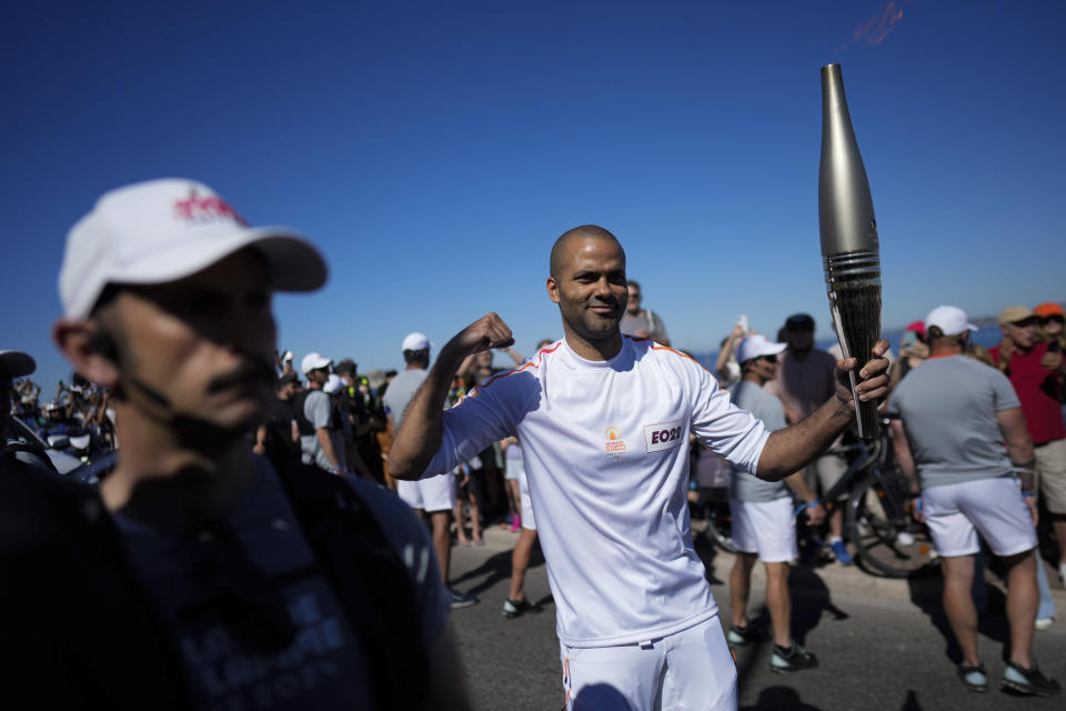 French torchbearer Tony Parker participates in the first stage of the Olympic torch relay in Marseille, southern France, Thursday, May 9, 2024. Torchbearers are to carry the Olympic flame through the streets of France' s southern port city of Marseille, one day after it arrived on a majestic three-mast ship for the welcoming ceremony. (AP Photo/Thibault Camus)