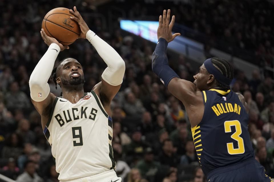Milwaukee Bucks' Wesley Matthews shoots past Indiana Pacers' Aaron Holiday during the second half of an NBA basketball game Sunday, Dec. 22, 2019, in Milwaukee. The Bucks won 117-89. (AP Photo/Morry Gash)