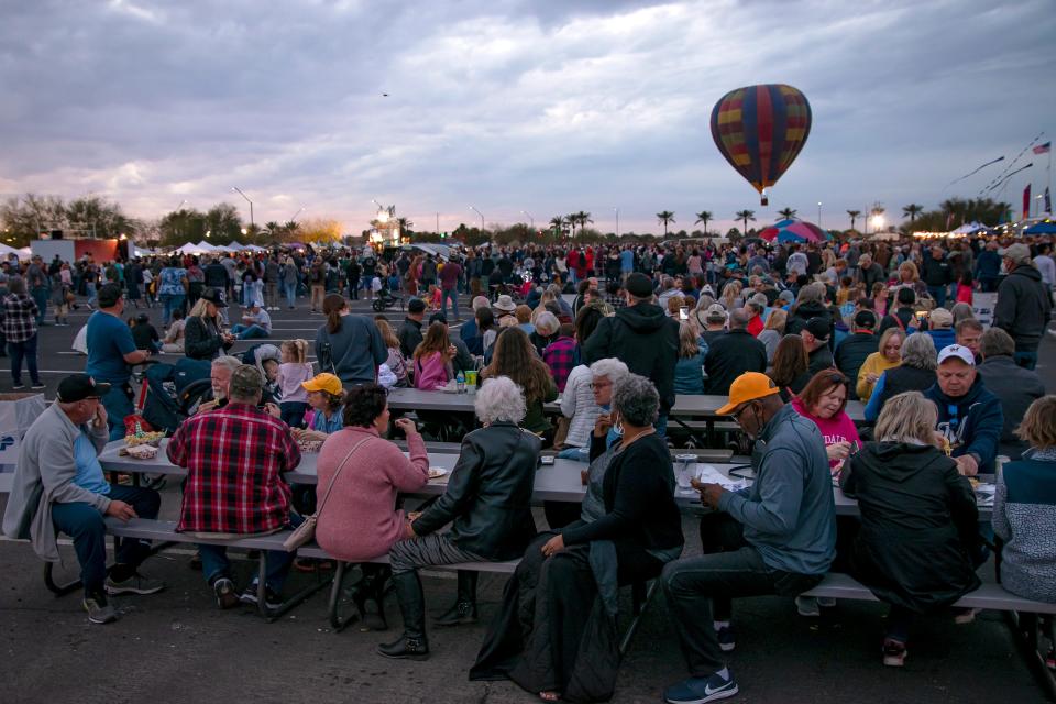 Residents pitched ideas for the future land use of the Goodyear Ballpark area to city officials at a January open house. A crowd eats at picnic tables and watch the Arizona Balloon Classic event in the ballpark on Jan. 29, 2022.