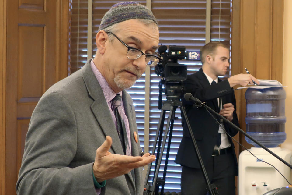 In this Wednesday, Feb. 19, 2020 photo, Rabbi Moti Rieber, executive director of the Kansas Interfaith Alliance, testifies against a bill to bar cities and counties from banning single-use plastic bags and straws, at the Statehouse in Topeka, Kan. Rieber says he's frustrated that lawmakers are considering such a measure and not having a meaningful conversation about climate change. (AP Photo/John Hanna)