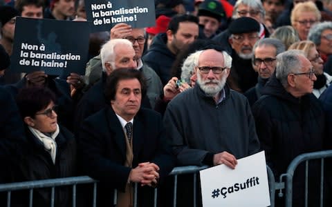 A man holds a sign reading "It's enough" (#Casuffit) as he takes part in a rally against anti-Semitism on the Republic Square on February 19, 2019 in Paris, France - Credit: Getty Images Europe