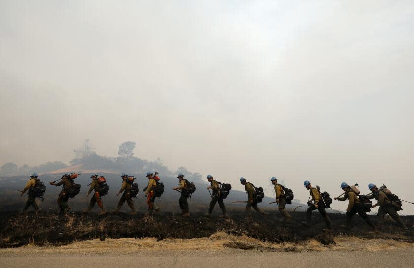 Members of the Arrowhead Hot Shot crew work to build a fire line as they continue to fight the Lake Fire, in Santa Barbara County, California on July 7, 2024. The fire, which began late July 5 near Zaca Lake, has spread to over 13,000 acres (5,260 hectares) over the weekend in Santa Barbara County, prompting evacuation warnings, according to county officials. (Photo by Daniel Dreifuss / AFP) (Photo by DANIEL DREIFUSS/AFP via Getty Images)