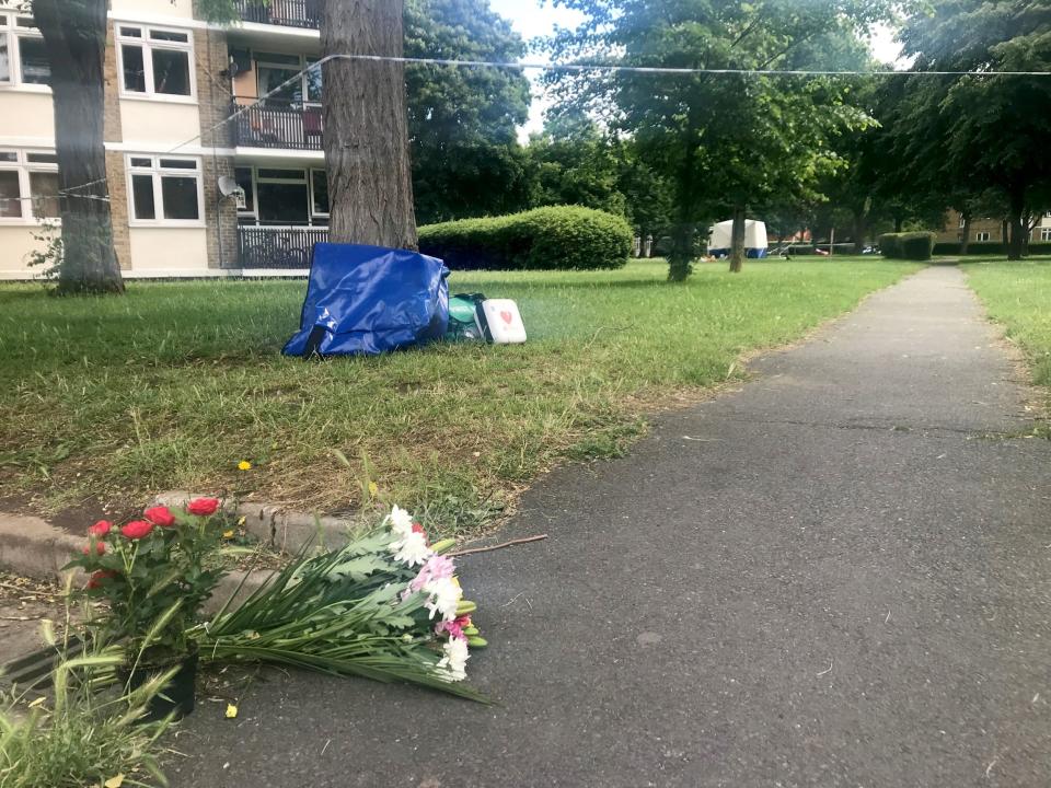 Flowers and medical equipment left near to the scene in Wandsworth (PA)