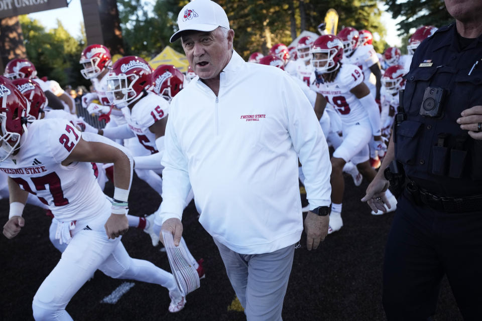 FILE - Fresno State head coach Jeff Tedford leads his players on to the field before the first half of an NCAA college football game Saturday, Oct. 7, 2023, in Laramie, Wyo. Fresno State coach Jeff Tedford is stepping away from the program because of personal health concerns. The school's athletic director, Terry Tumey, announced Tedford's status on Friday, Dec. 1. (AP Photo/David Zalubowski, File)