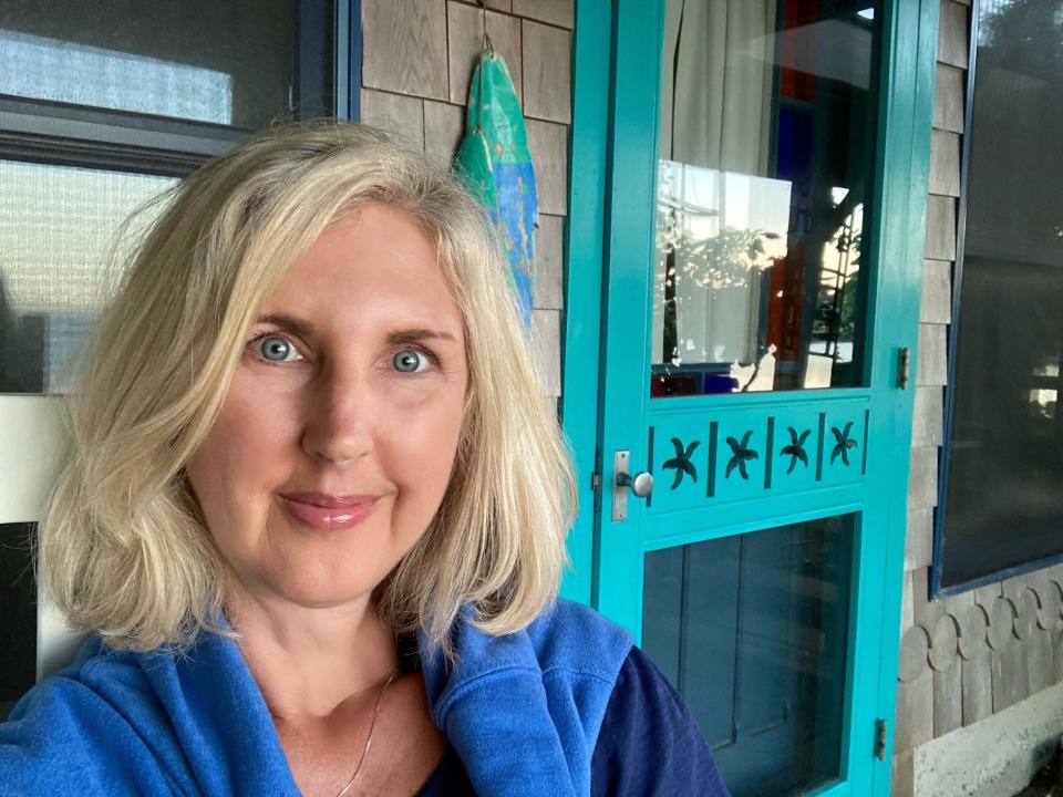 Blonde woman with blue eyes taking selfie on an airbnb porch in Maine, Courtenay Rudzinski, airbnb review