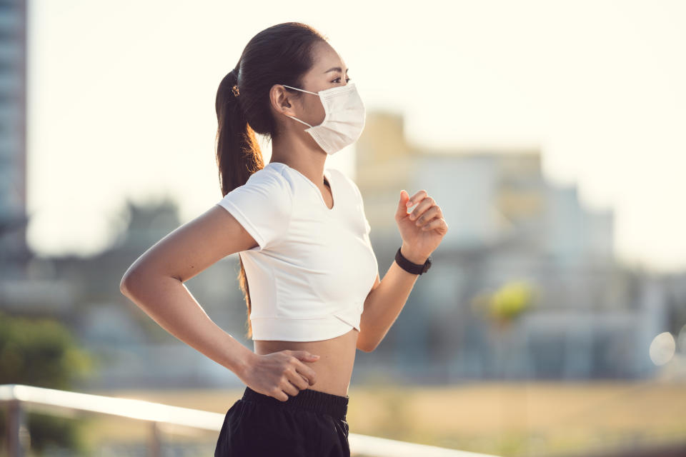 Woman runners morning exercise she wears a nose mask. Protection against dust and viruses