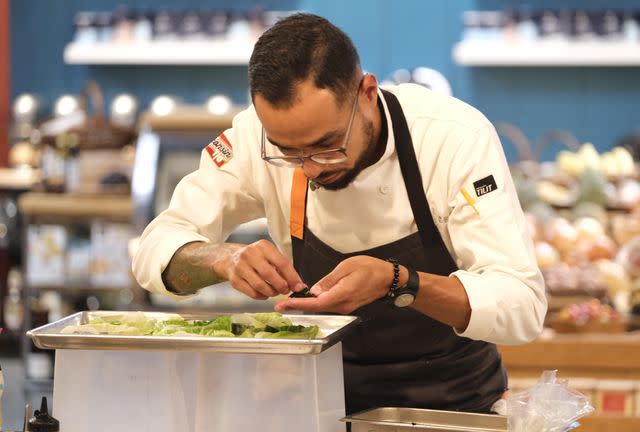 <p>David Moir / Bravo</p> Top Chef's Danny Garcia preps cabbage for the "Chaos Cuisine" elimination challenge.