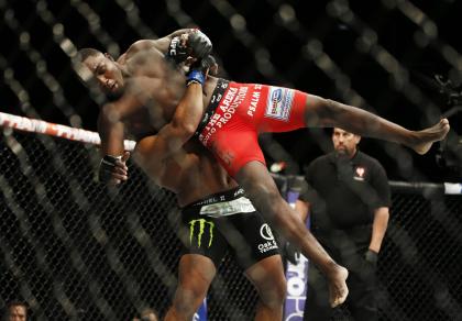 Daniel Cormier lifts Anthony Johnson into the air during their UFC 187 fight. (AP)