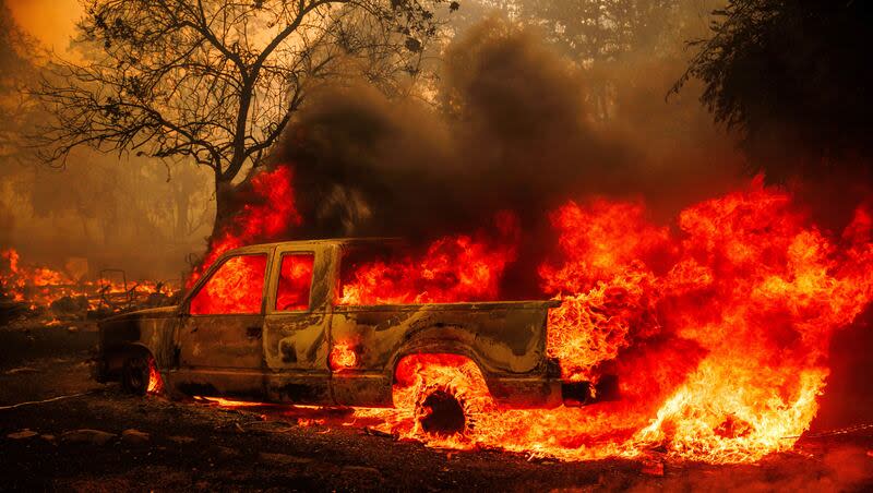 A property is engulfed in flames as the Thompson Fire burns, Tuesday, July 2, 2024, in Oroville, Calif. An evacuation order has been issued for 13,000 residents in Oroville, California, due to a wildfire that has spread to residential areas.