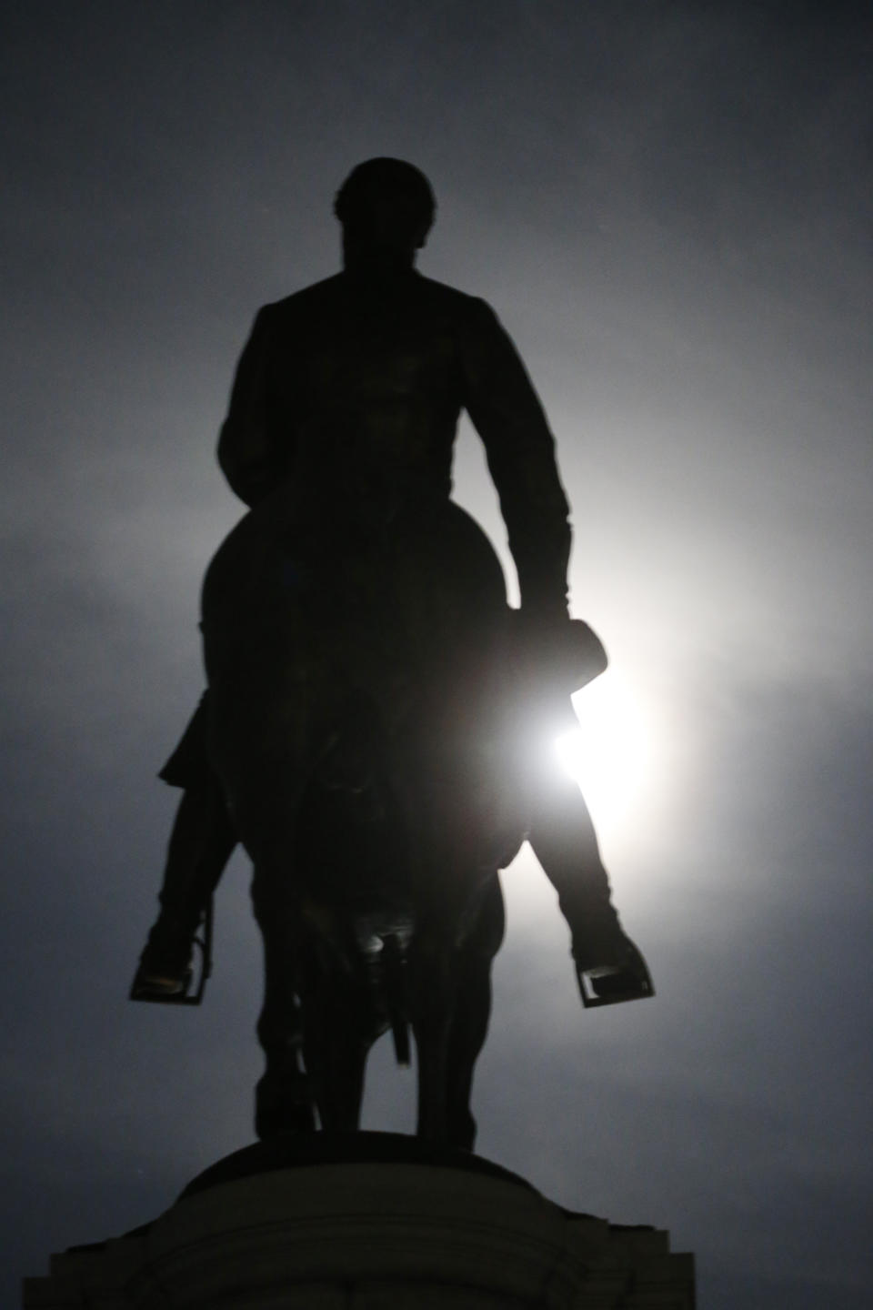 The Moon illuminates the statue of Confederate General Robert E. Lee on Monument Avenue Friday June. 5, 2020, in Richmond, Va. Virginia Gov. Ralph Northam has ordered the removal of the statue. (AP Photo/Steve Helber)