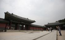 People walk at the Changdeokgung Palace in Seoul.