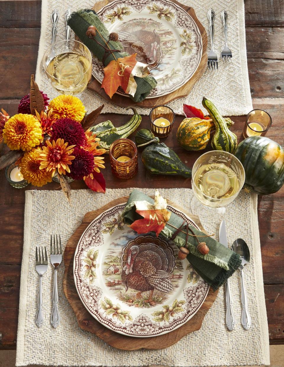 <p>Nature is the theme of this classically fall hued table. Hot glue acorns to lengths of brown waxed twine and use to tie up rolled napkins. Apply gold leaf to a portion of a preserved maple leaf and use a gold paint pen to mark with guest's initials.</p><p><a class="link " href="https://www.amazon.com/Solino-Home-Linen-Dinner-Napkins/dp/B07GR4VZJS/ref=sr_1_1_sspa?tag=syn-yahoo-20&ascsubtag=%5Bartid%7C10050.g.2063%5Bsrc%7Cyahoo-us" rel="nofollow noopener" target="_blank" data-ylk="slk:SHOP NAPKINS;elm:context_link;itc:0;sec:content-canvas">SHOP NAPKINS</a></p>