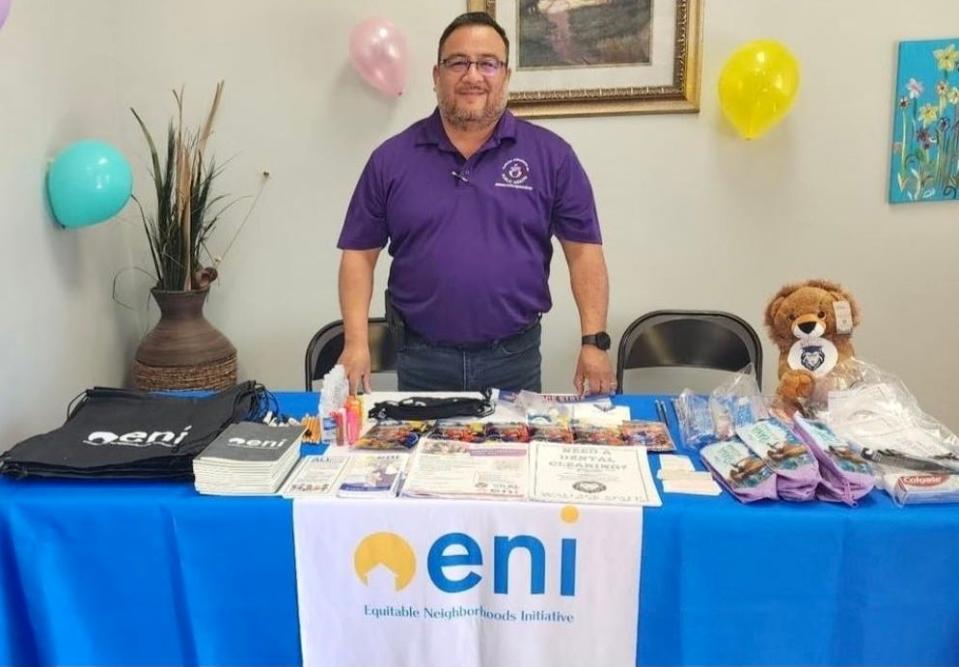 Greg Sarabia sets up a booth to showcase Equitable Neighborhoods Initiative at a health fair at Wills Family Medicine on April 15, 2023, in Collinsville, Alabama.