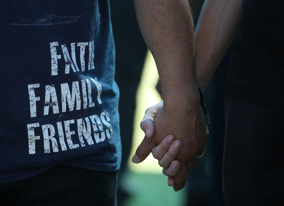 Vigil participants&nbsp;hold hands.&nbsp;