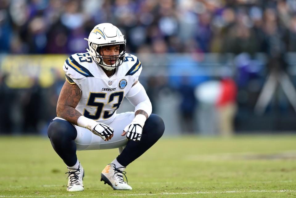 Los Angeles Chargers center Mike Pouncey kneels on the field during the second half of the team's NFL wild card playoff football game against the Baltimore Ravens.