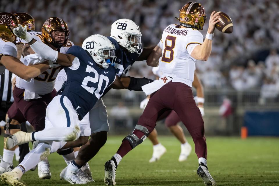 Pressure from Penn State's Adisa Isaac (20) and Kaleb Artis (58) force Minnesota quarterback Athan Kaliakmanis (8) to throw an incompletion and bring up fourth down during the second quarter at Beaver Stadium on Saturday, Oct. 22, 2022, in State College.
