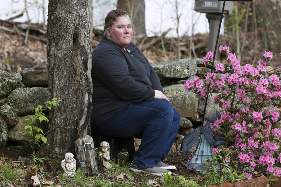 Jillian Philips sits for a portrait in a memorial garden at her home, Tuesday, May 2, 2023, in North Brookfield, Mass. The remains of her child Emilia, who died at 5 days old in 2015, are buried there along with remains of her 2016 miscarriage. Philips, who used the drug Mifepristone to manage her miscarriage, is concerned that other women who miscarry could suffer if the pill, also used for abortions, is taken off the market. (AP Photo/Reba Saldanha)