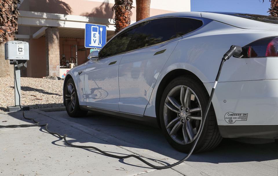 A Tesla is plugged into a charging station at Palm Springs City Hall, December 15, 2020. 