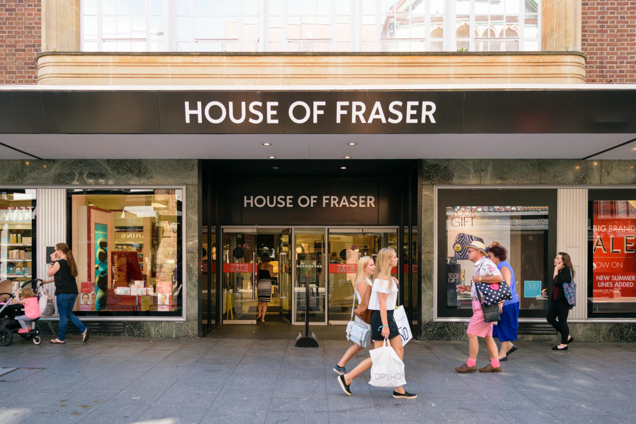 Exeter, Devon, United Kingdom - August 23, 2016: People pass by House of Fraser located on High street. House of Fraser is the third largest group of stores operating 60 shops in the UK.