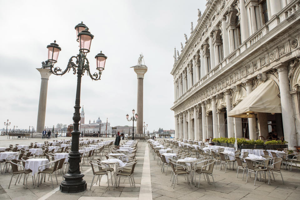 A waiter works in a restaurant in Venice, northern Italy, Saturday, May 1, 2021. Italy is gradually reopening after six months of rotating virus closures allowing outdoor dining. (Filippo Ciappi/LaPresse via AP)