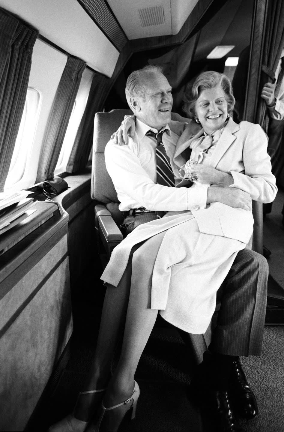 <p>President Gerald R. Ford and his wife Betty Ford share a moment during a flight en route to Oman in 1979. </p>