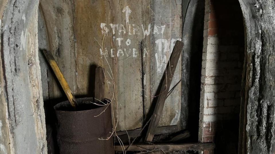 Concrete shelter with "stairway to heaven" graffiti